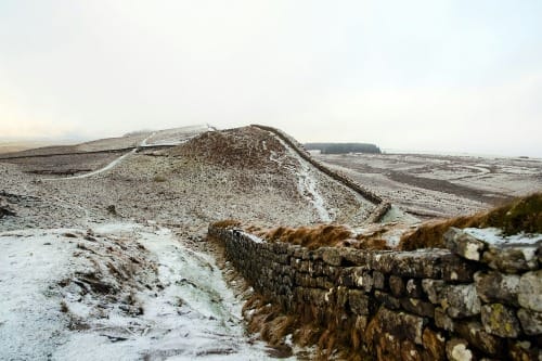 landscape photography of grey bricked wall near mountain